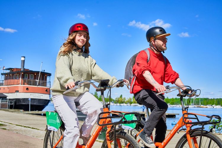 Two people biking on a sunny day.